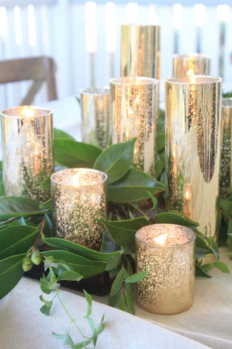 image of gold candle holder centrepiece with foliage on table